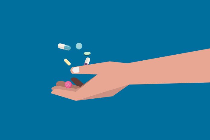 A hand full of tablets showing NHS negotiates deals on adalimumab biosimilars