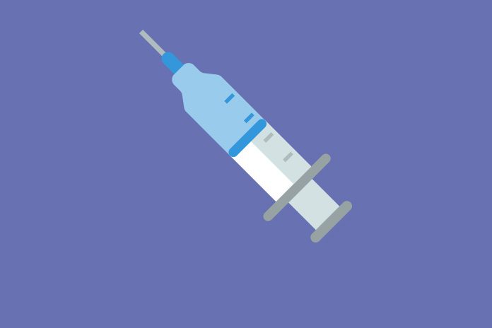 Image of a syringe with blue liquid on a blue background to show Government pledges investment for coronavirus vaccine